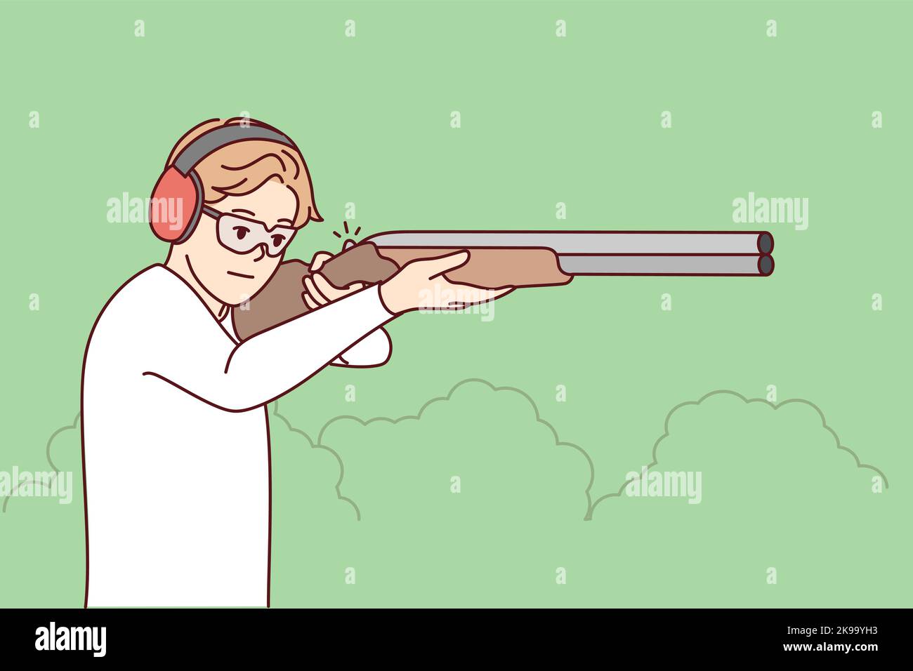 Man in headphones and glasses shoot with rifle in shooting gallery. Guy