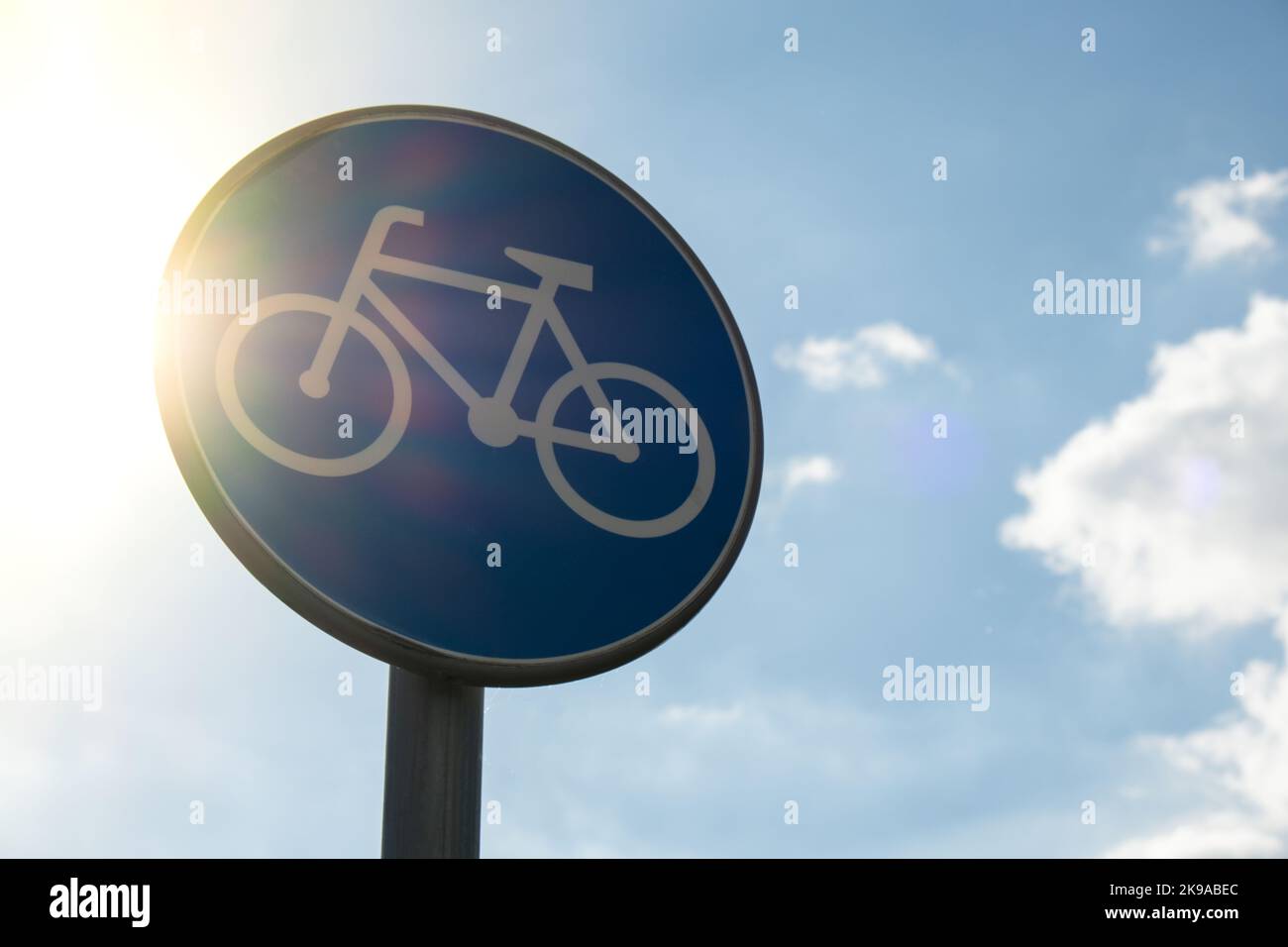Round road sign depicting white bicycle on blue background, meaning