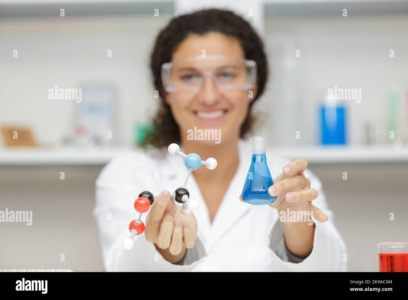female scientist holding model atoms and glass flask Stock Photo Alamy