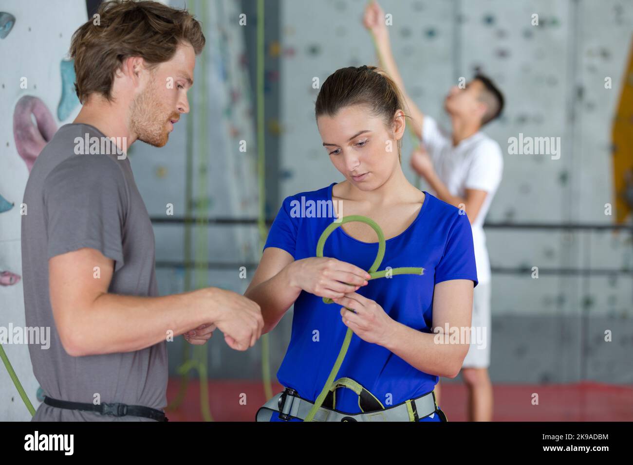 wall climbing beginner trying a knot Stock Photo Alamy