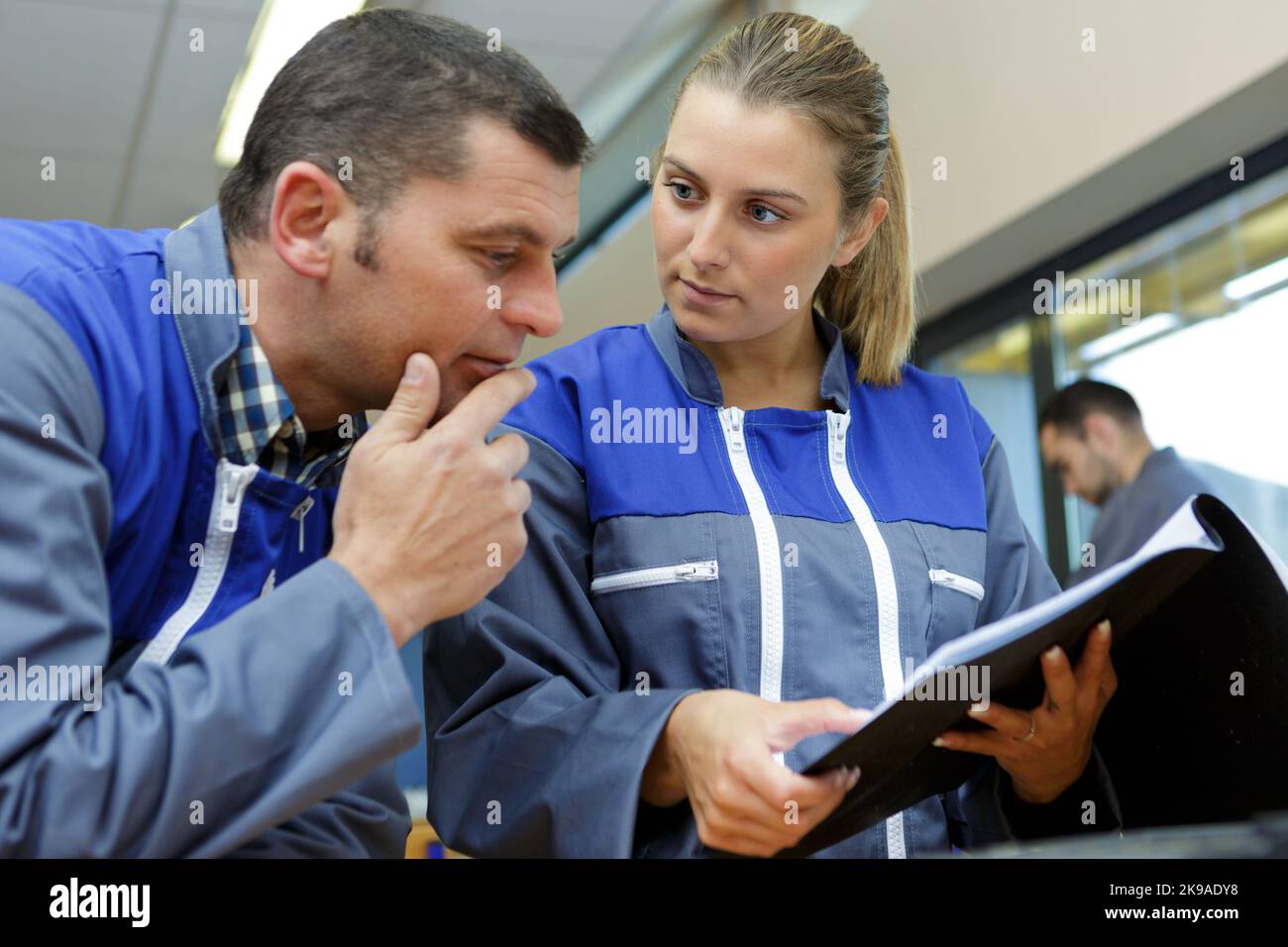 happy male and female workers with folder Stock Photo - Alamy