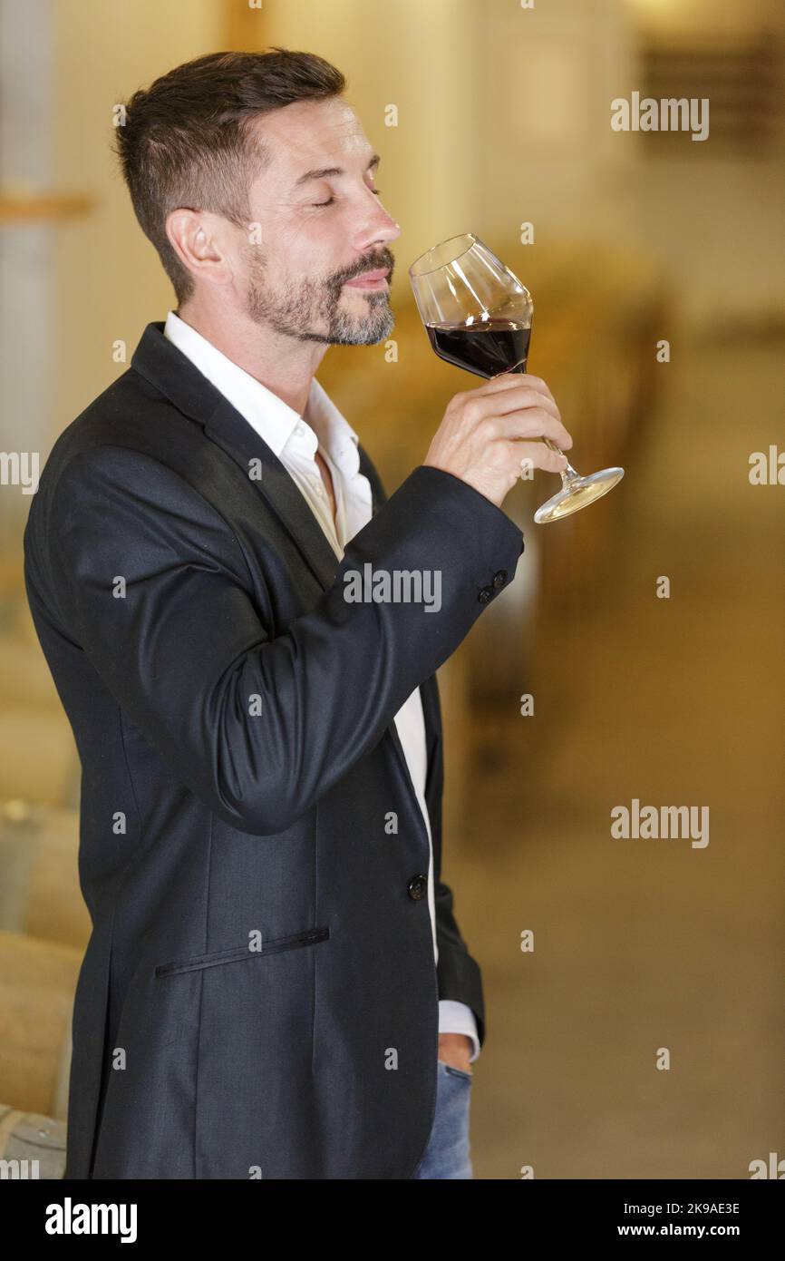 adult man having wine tasting in cellar with woods Stock Photo - Alamy