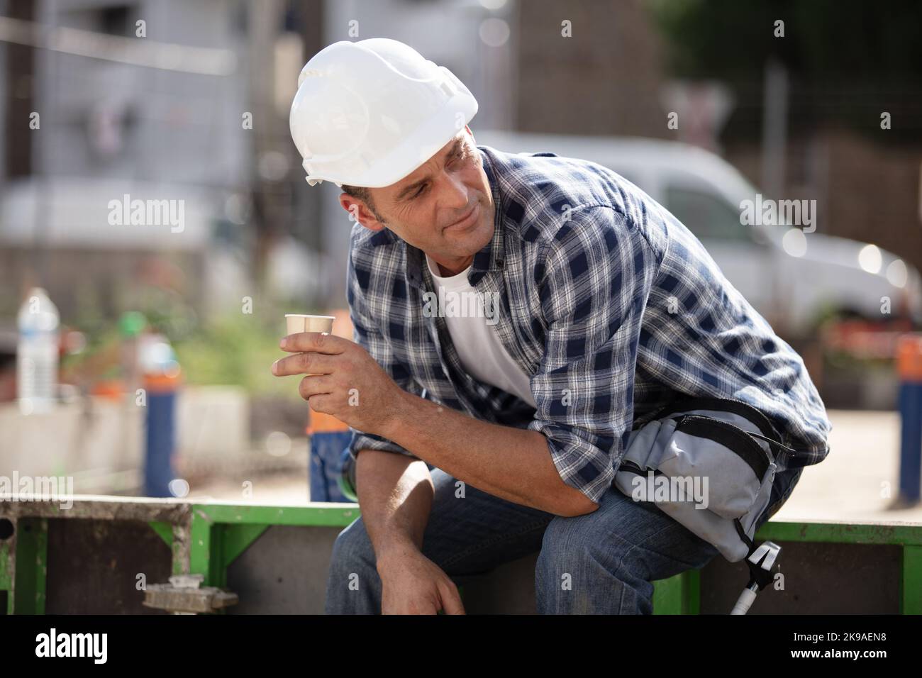 happy mid adult construction worker taking a break Stock Photo
