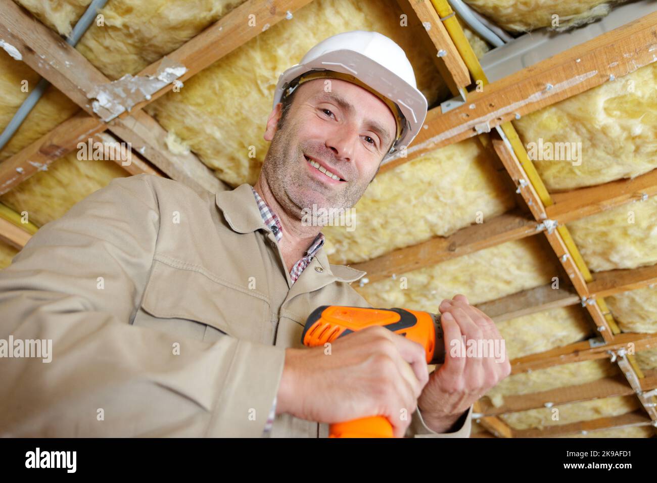 a carpenter drilling wooden plank Stock Photo