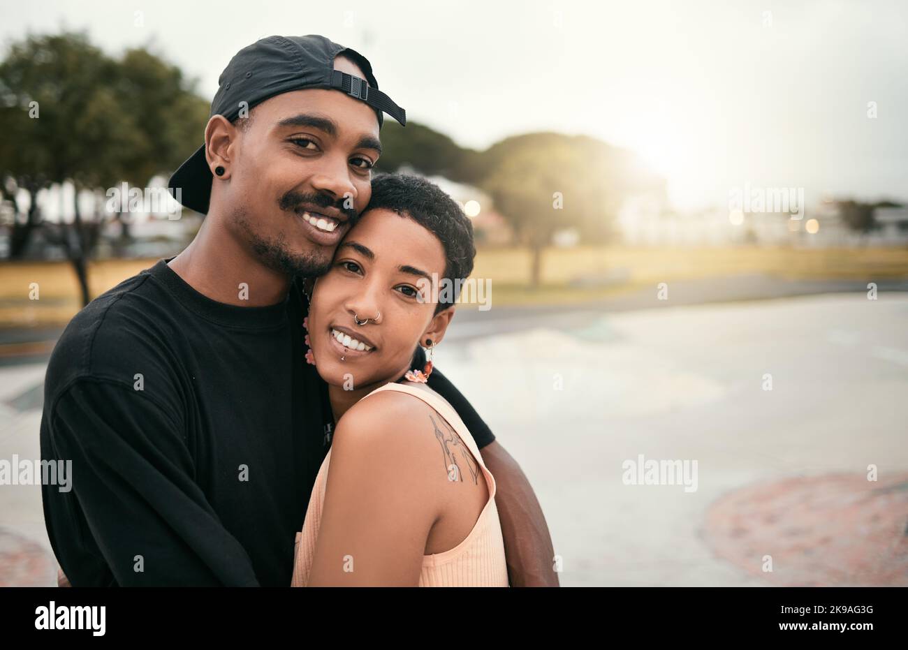 Skate, love and portrait of black couple hug in city enjoying weekend, free time and summer. Skating, trendy fashion and young black man and woman in Stock Photo
