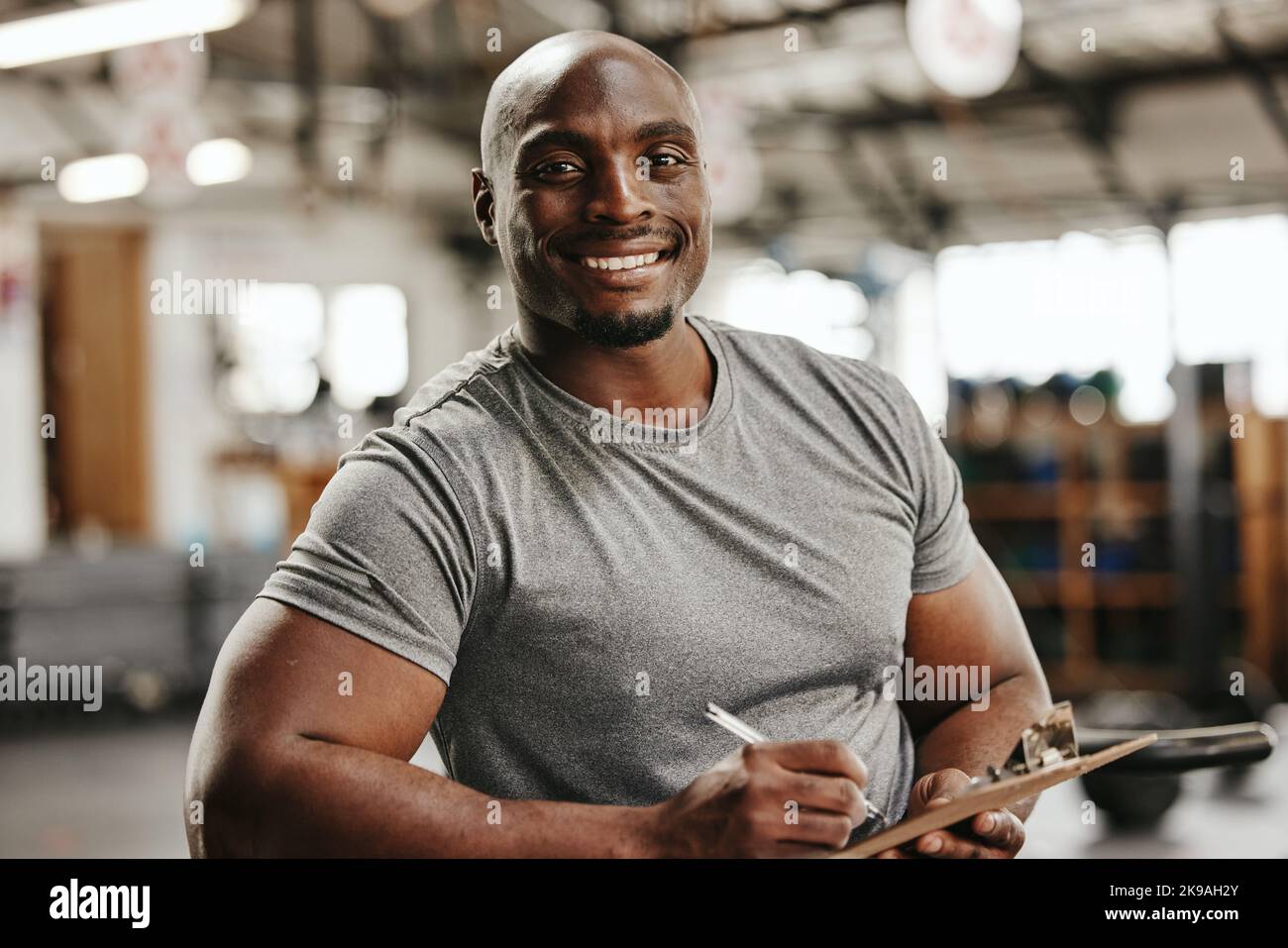 Gym, documents or black man writing on clipboard for membership, sign ...