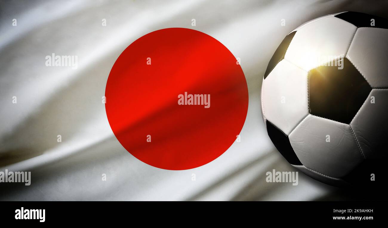 Japan national team composition with classic ball on grass and flag in the background. Top view. Stock Photo