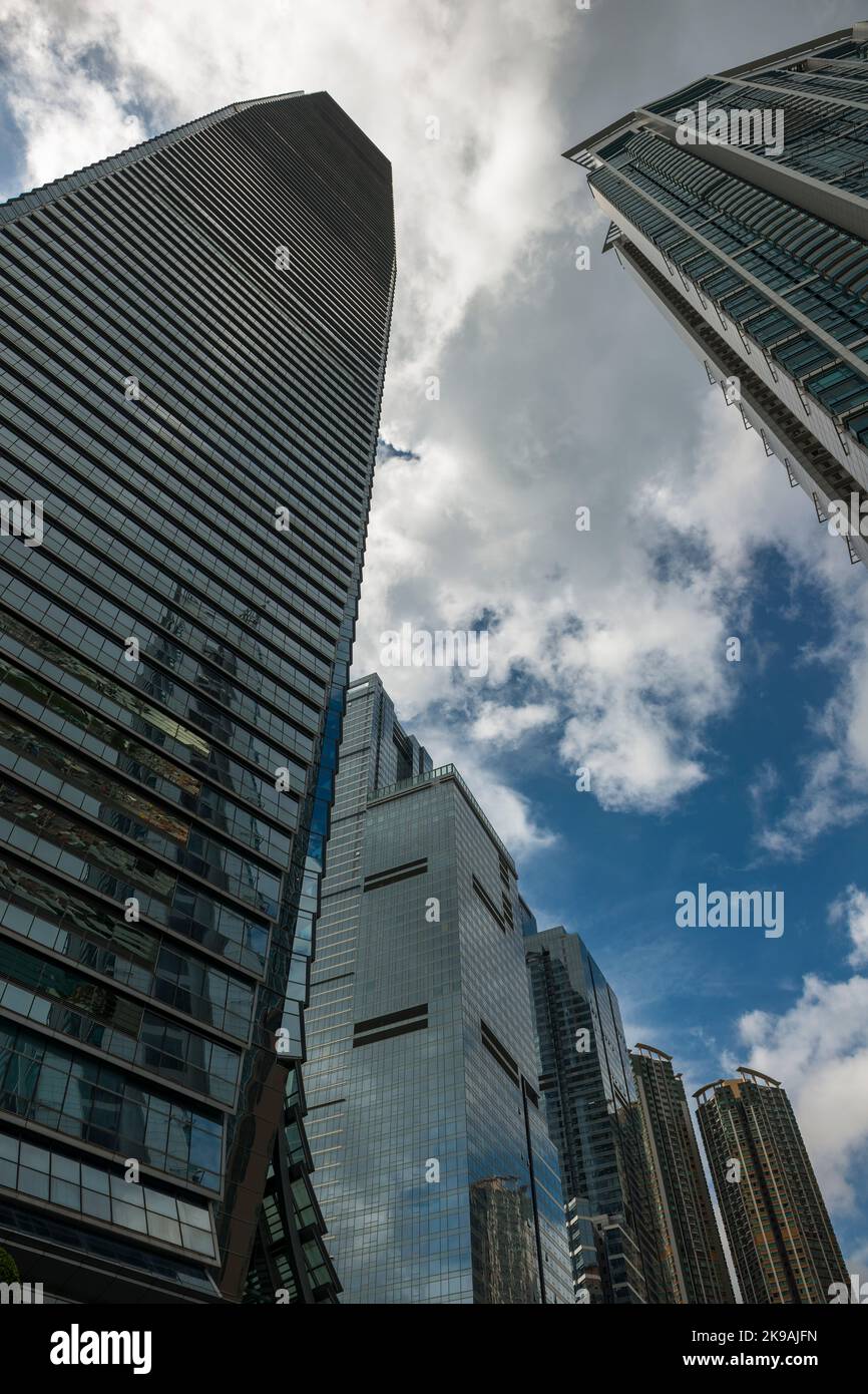 The distinctive curved base of the curtain wall of the ICC, with The Cullinan. Sorrento and The Harbourside, Union Square, West Kowloon, Hong Kong Stock Photo