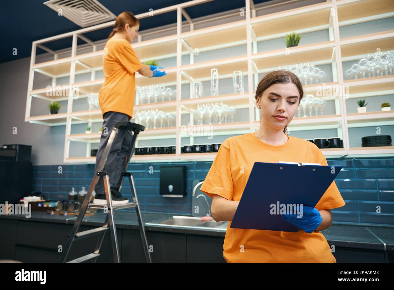 Cleaning company workers checking list cleaned areas in coworking space Stock Photo Alamy