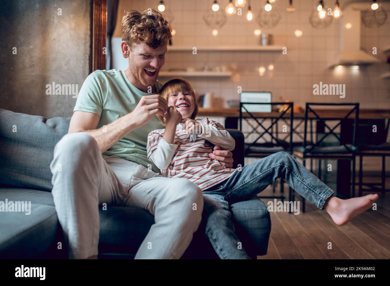 Father showing his little son how to get dressed Stock Photo