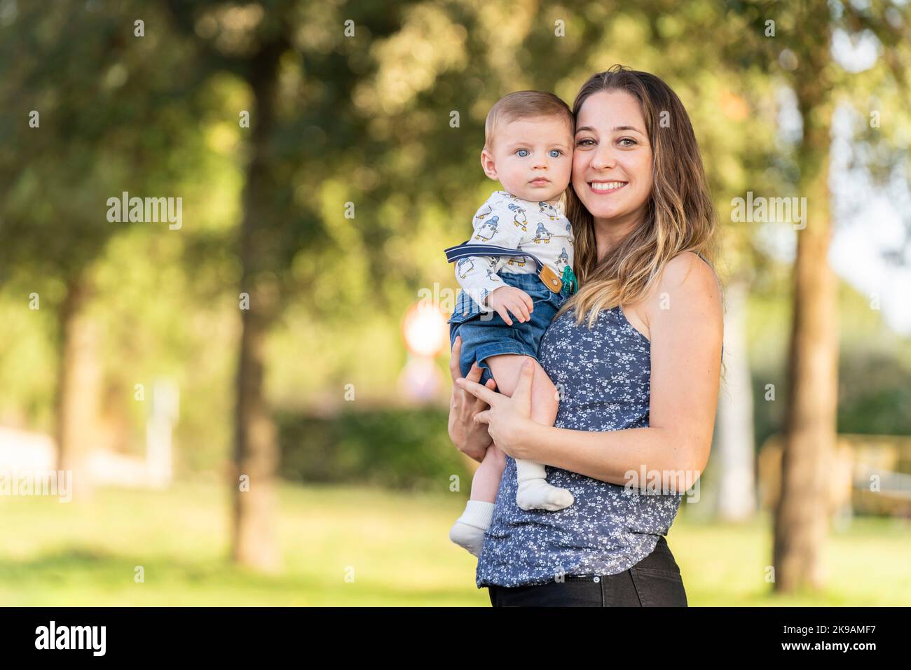Mother and her son in the park looking at the camera. Stock Photo