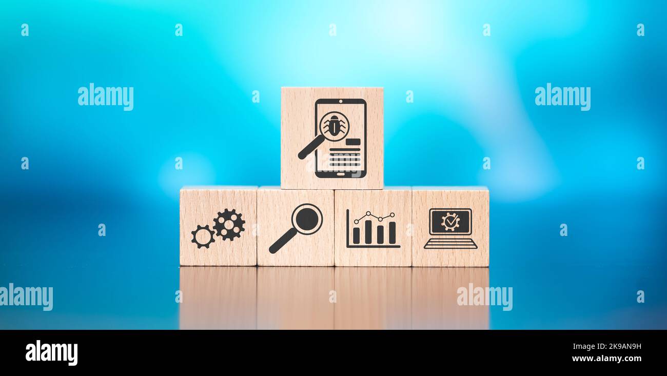 Wooden blocks with symbol of software testing concept on blue ...