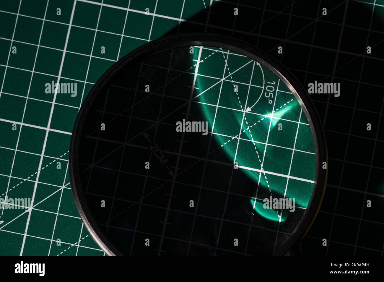 Magnifying glass on cutout plane Stock Photo Alamy