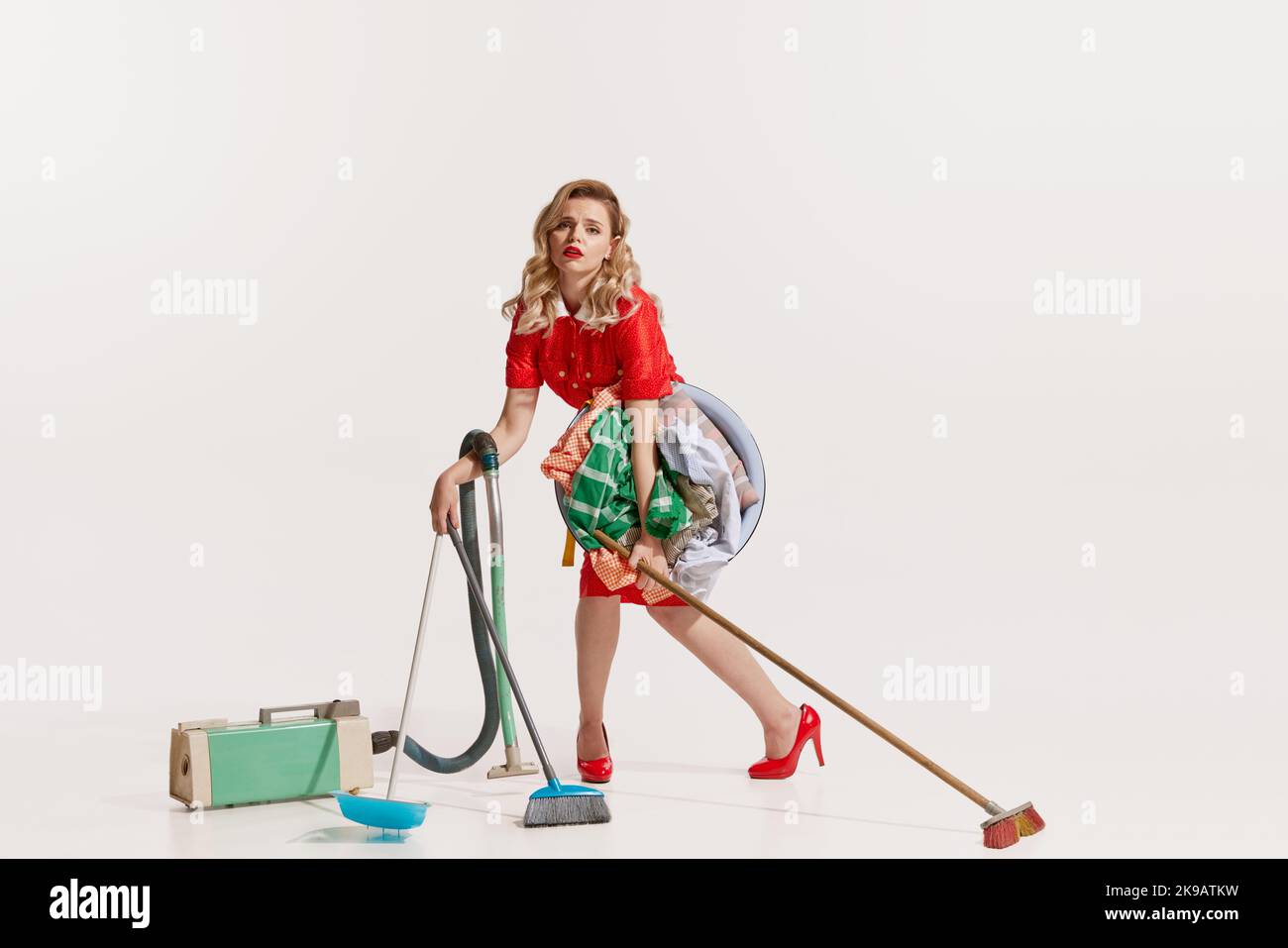 Portrait of beautiful tired woman vacuuming, mopping and washing