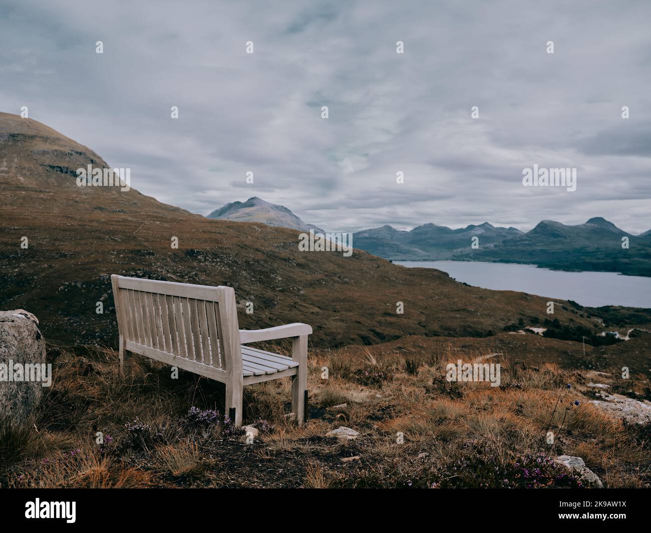 A public bench seat in the remote scottish mountain landscape of Upper Loch Torridon, Wester Ross, Scotland UK Stock Photo