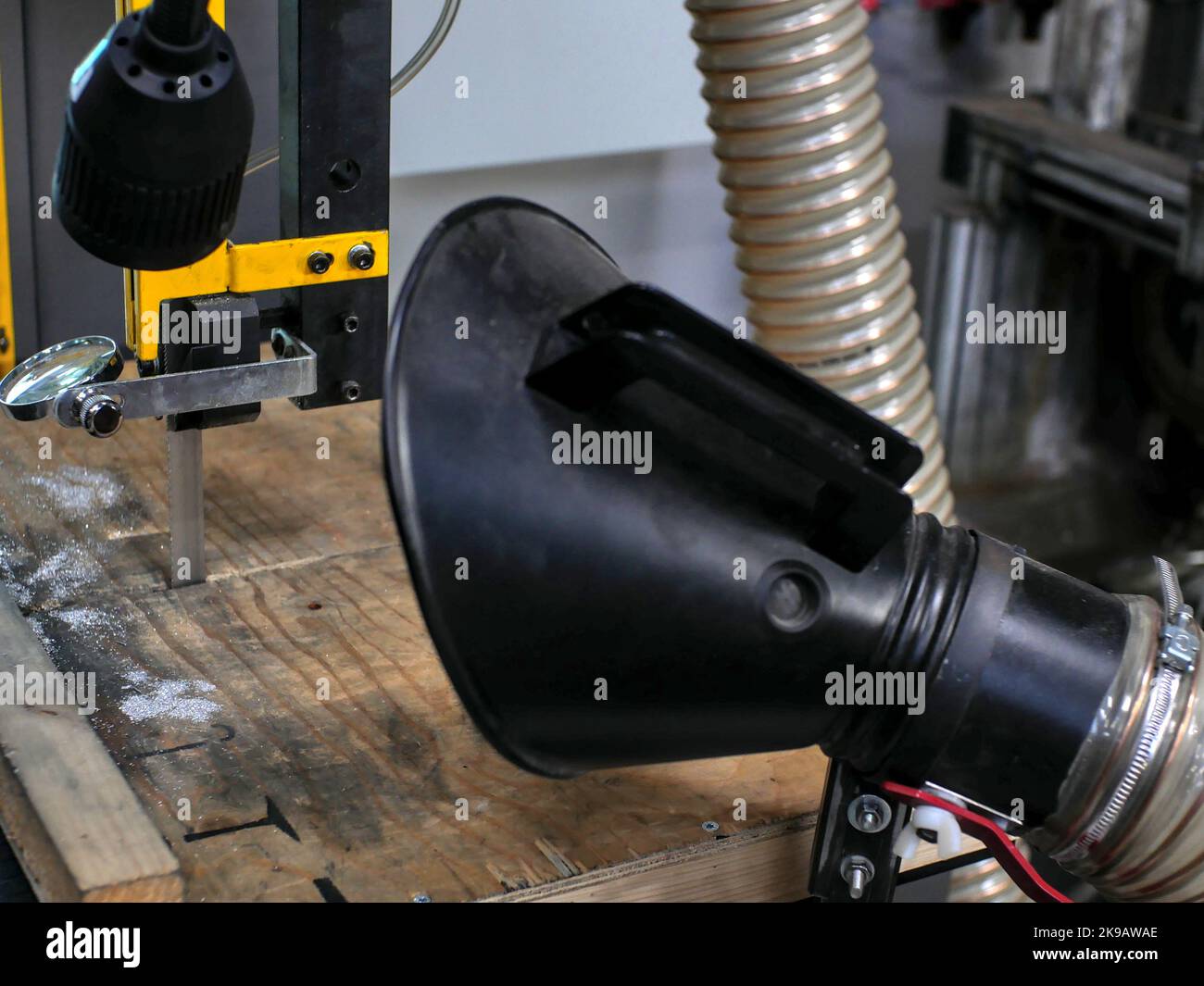 Guide system for a diamond band saw blade. In blurred foreground, a dust extraction device Stock Photo