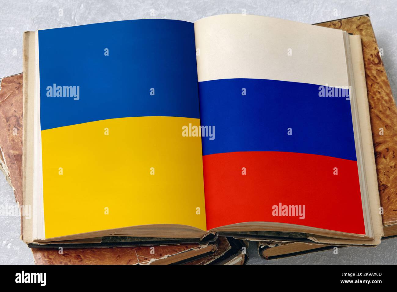 Russian Note Pad Ukrainian and Russian flags on the pages of an open vintage book ...