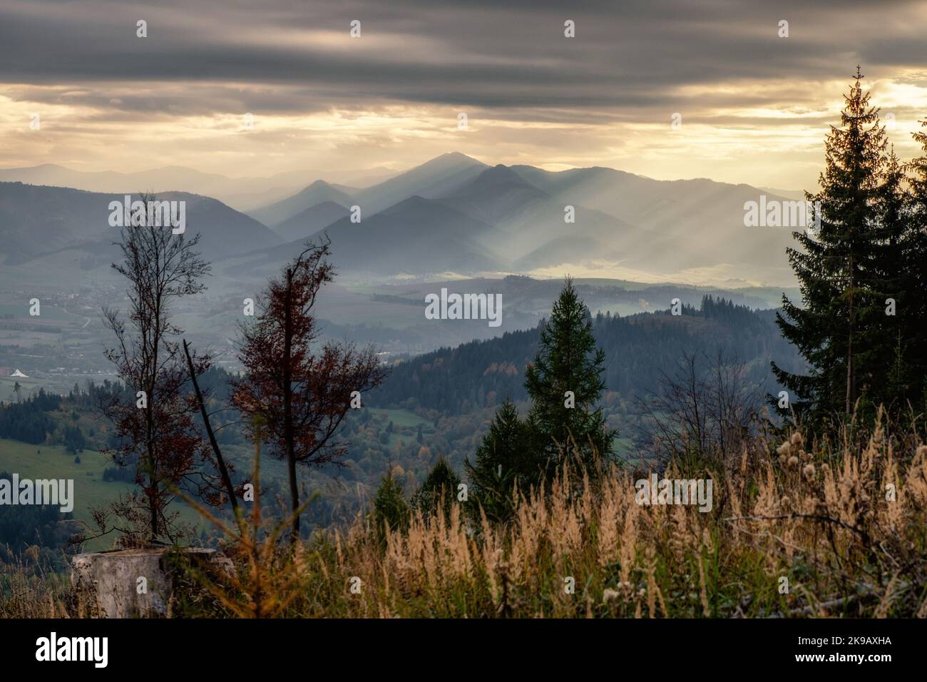Sunshine through dark clouds. Cloudy sky sunrays. Sunrays in cloudy sky. Stock Photo