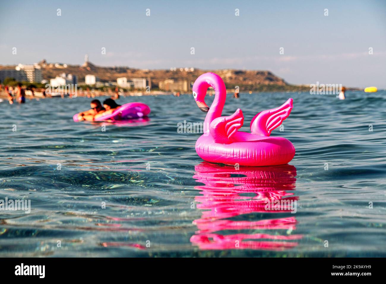 pink flamingo inflatable on the sea at resort Faliraki in Rhodes island, Greece Stock Photo
