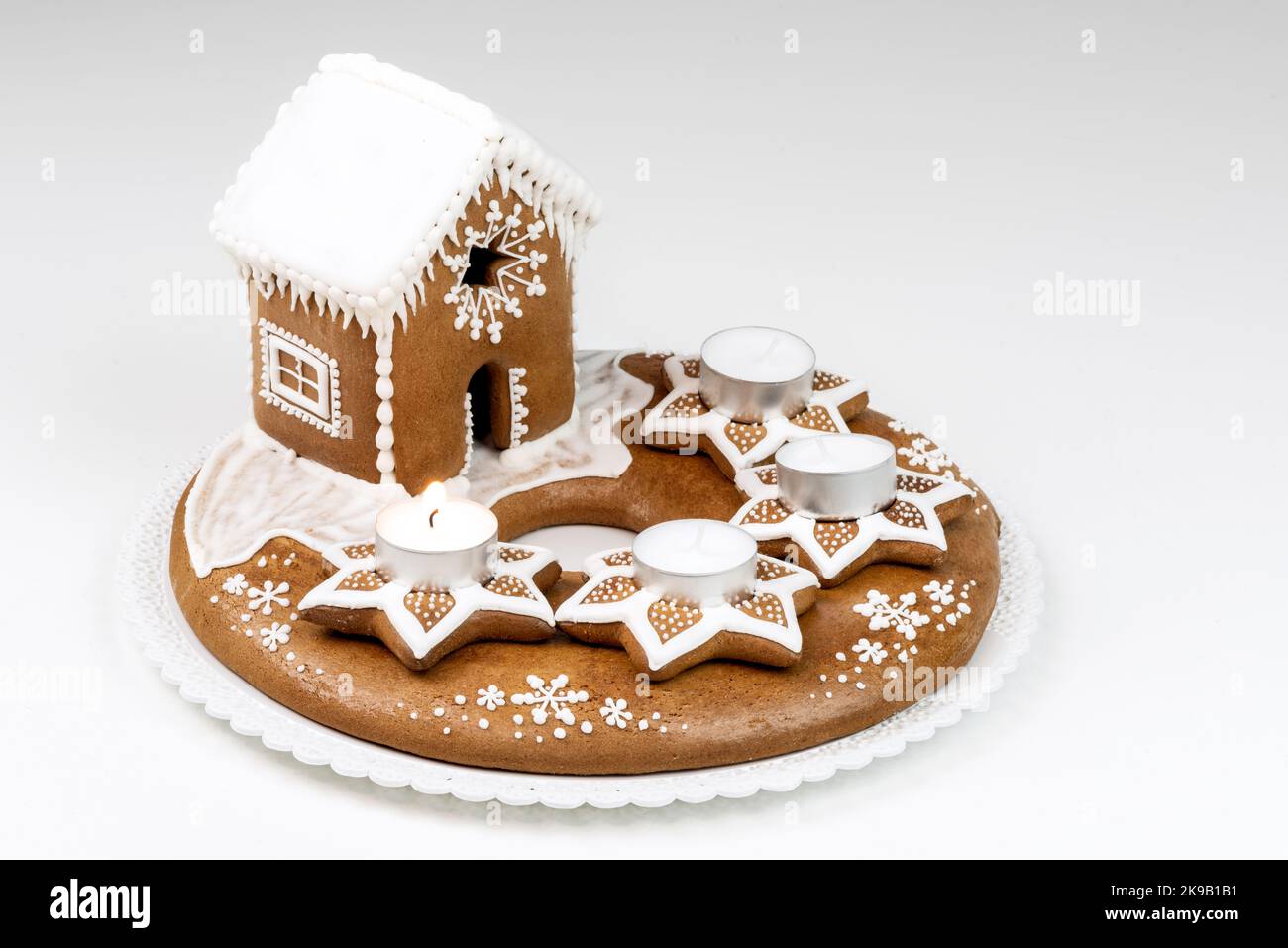 Isolated advent candlestick with lit first candle and christmas