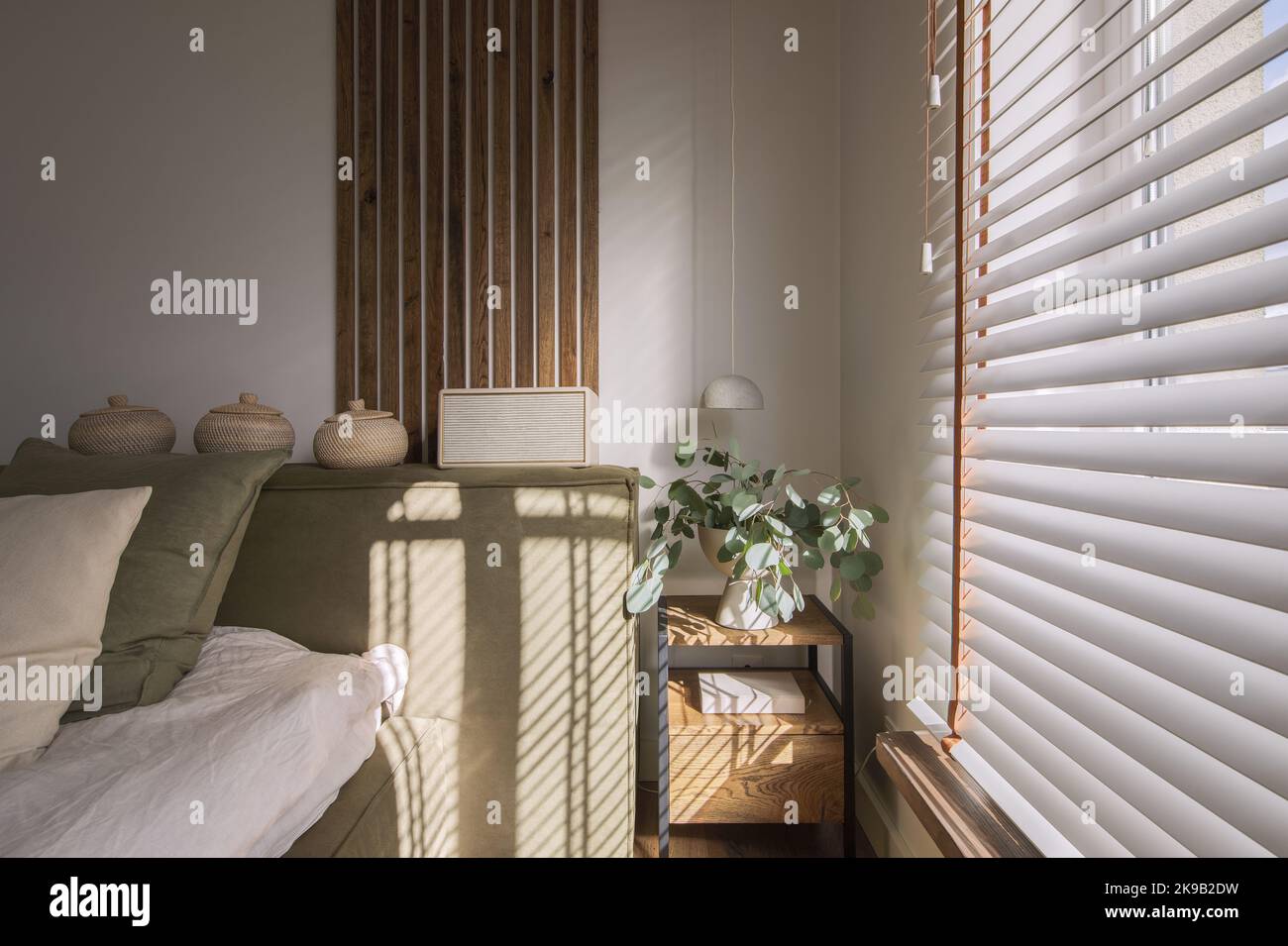 Modern Japandi bedroom interior design in earth tones, natural textures with wooden solid oak furniture. Japandi concept Stock Photo