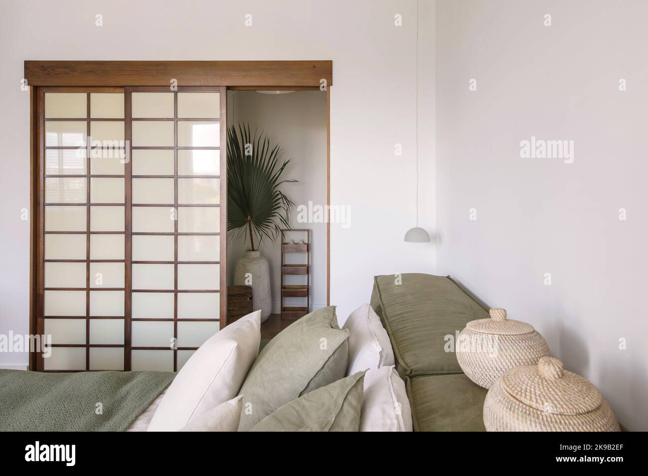 Modern Japandi bedroom interior design in earth tones, natural textures with wooden solid oak furniture. Japandi concept Stock Photo