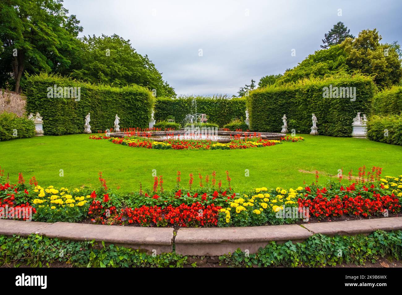 The Ferdinand Tietz Fountain, surrounded by flowerbeds and white statues designed by Ferdinand Tietz, in the northern part of the Palastgarten, the... Stock Photo