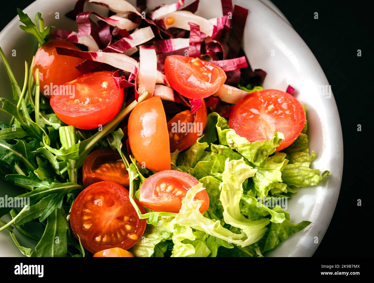 Mixed salad with lettuce,tomato and fresh rucola leaves. vegetarian dish. Stock Photo