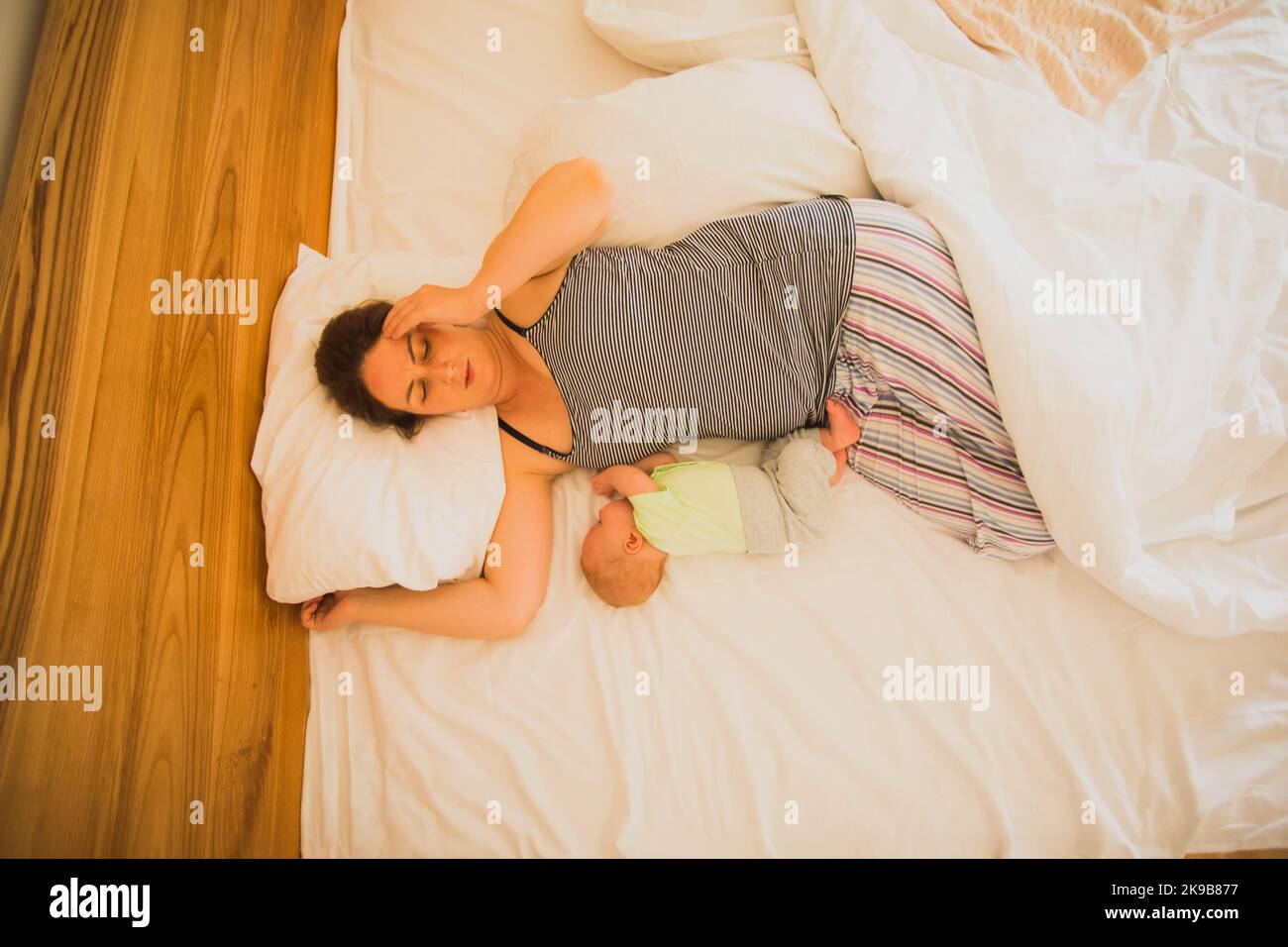 Mother and newborn baby sleep in the bed Stock Photo Alamy