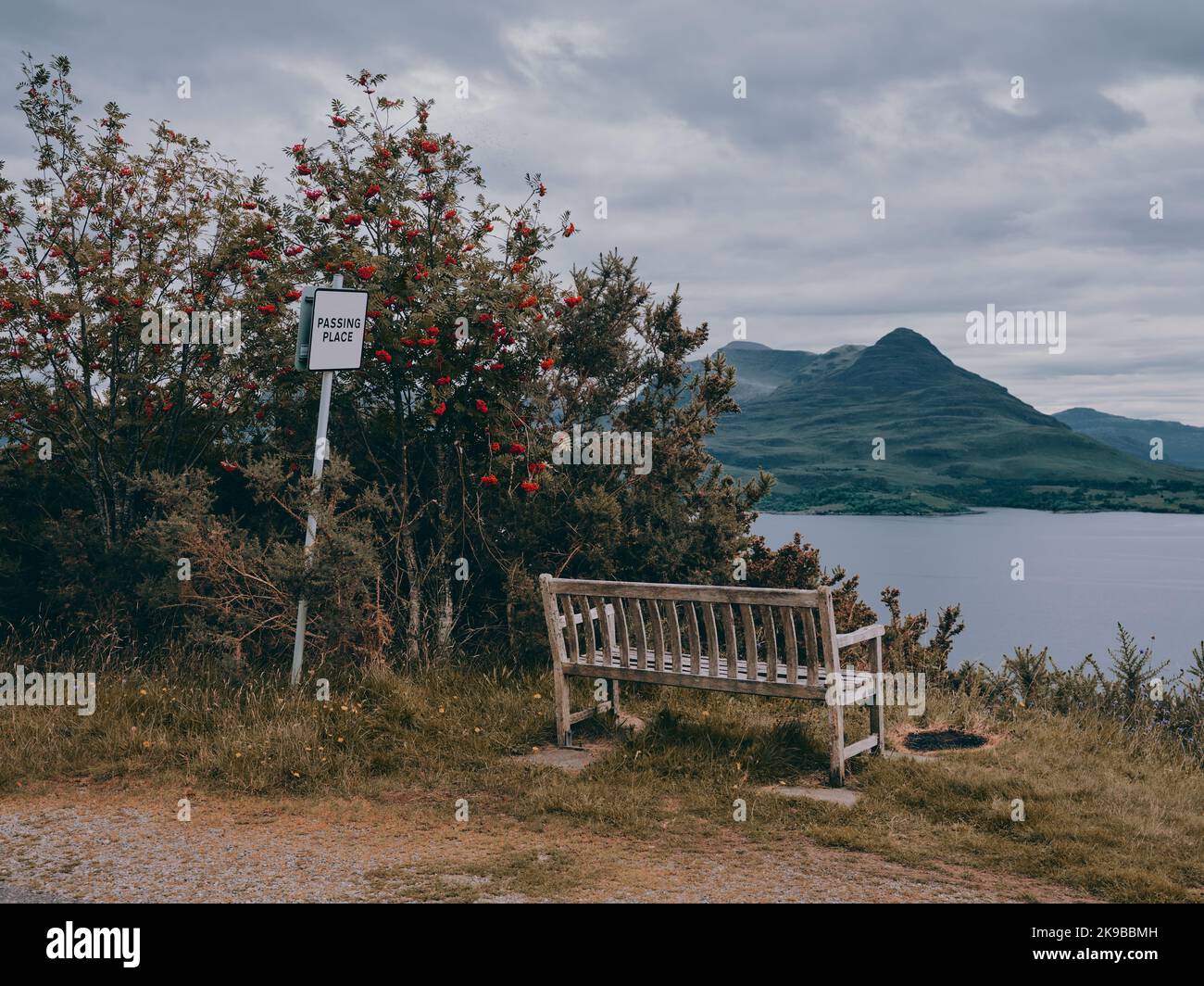 A public bench seat and passing place sign in the remote scottish mountain landscape of Upper Loch Torridon, Wester Ross, Scotland UK Stock Photo