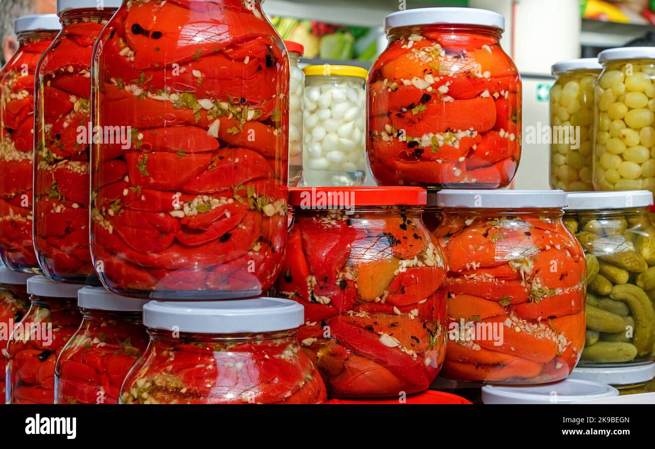 Homemade organic pickled vegetables in glass jars sold on market Stock Photo