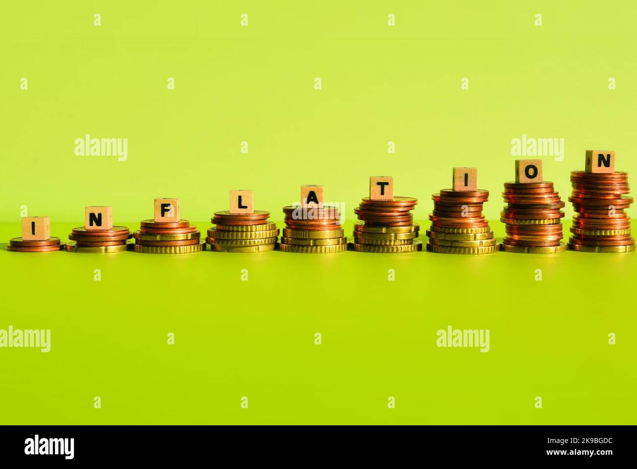 the word inflation on coin stacks Stock Photo