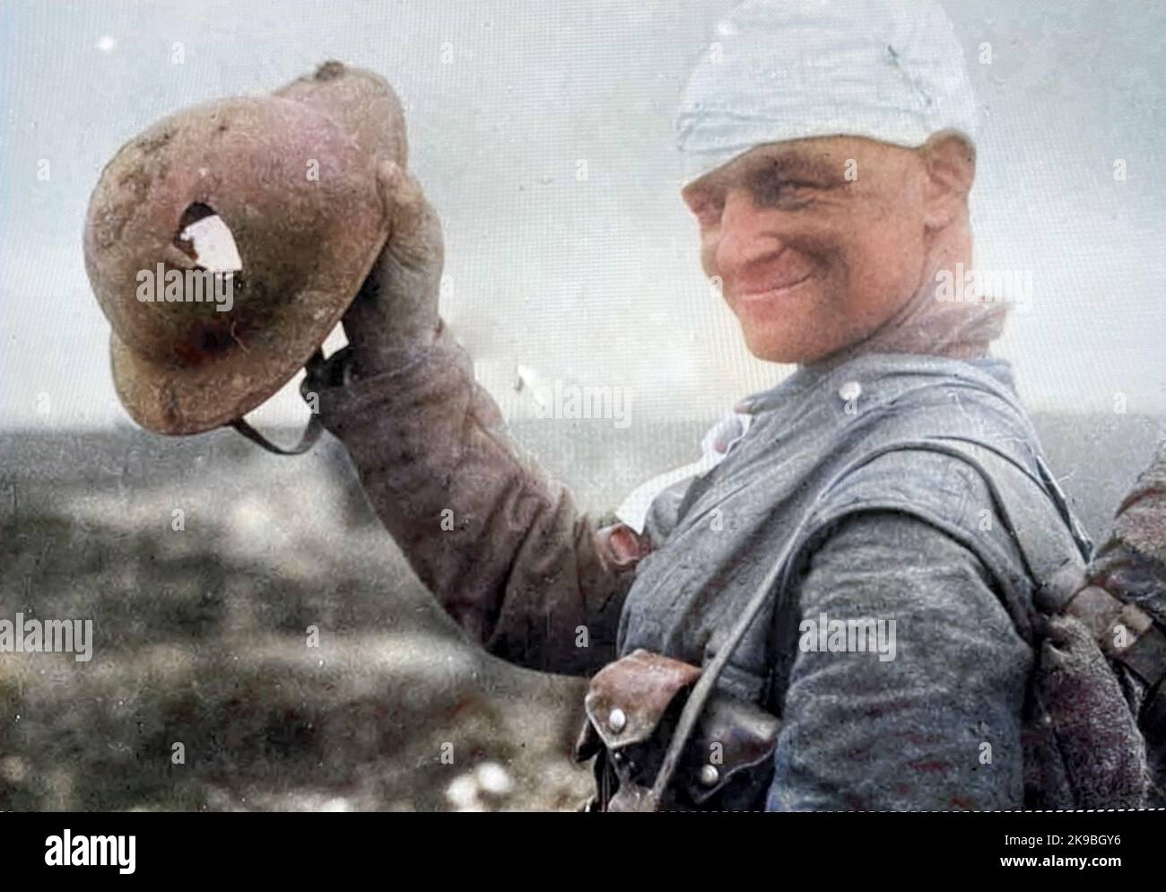 BRITISH SOLDIER WW1 proudly showing his holed helmet Stock Photo