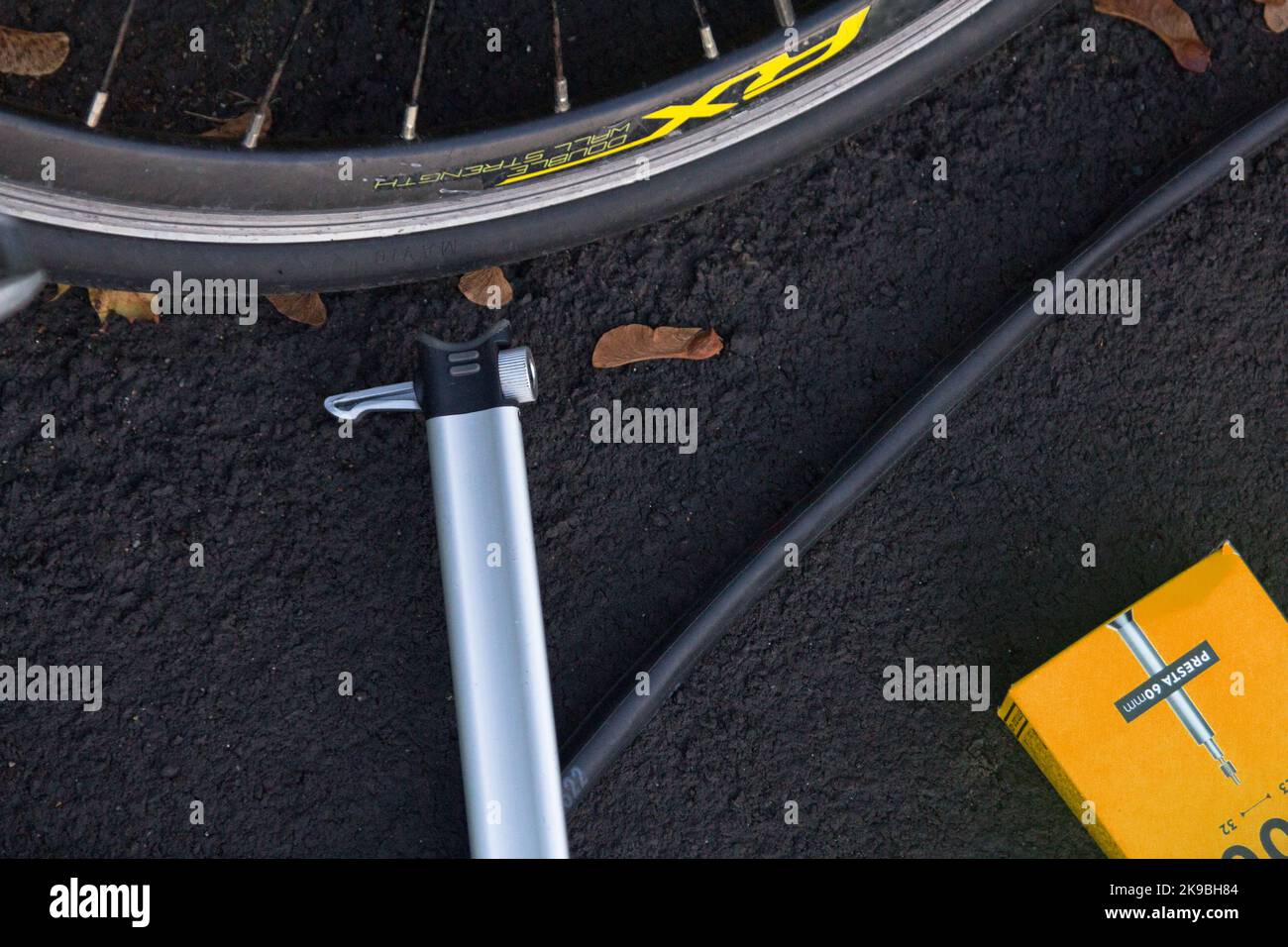 A bicycle wheel, pump, inner tube and new box Stock Photo