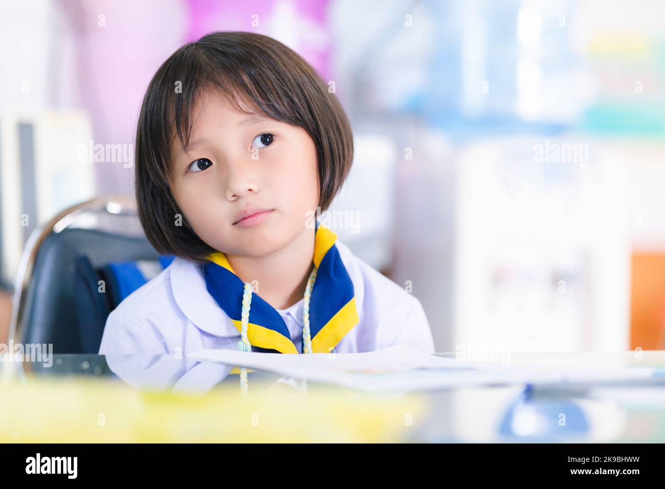 asian student girl sad or bored little student girl in uniform. child learning exam in classroom, solved examples, doing exercises in school workbook Stock Photo