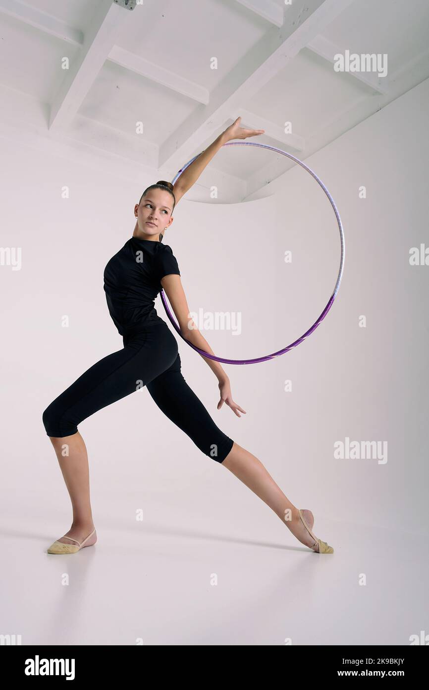 Hoop Deflection a girl from rhythmic gymnastics in a standing bodysuit shows an ...
