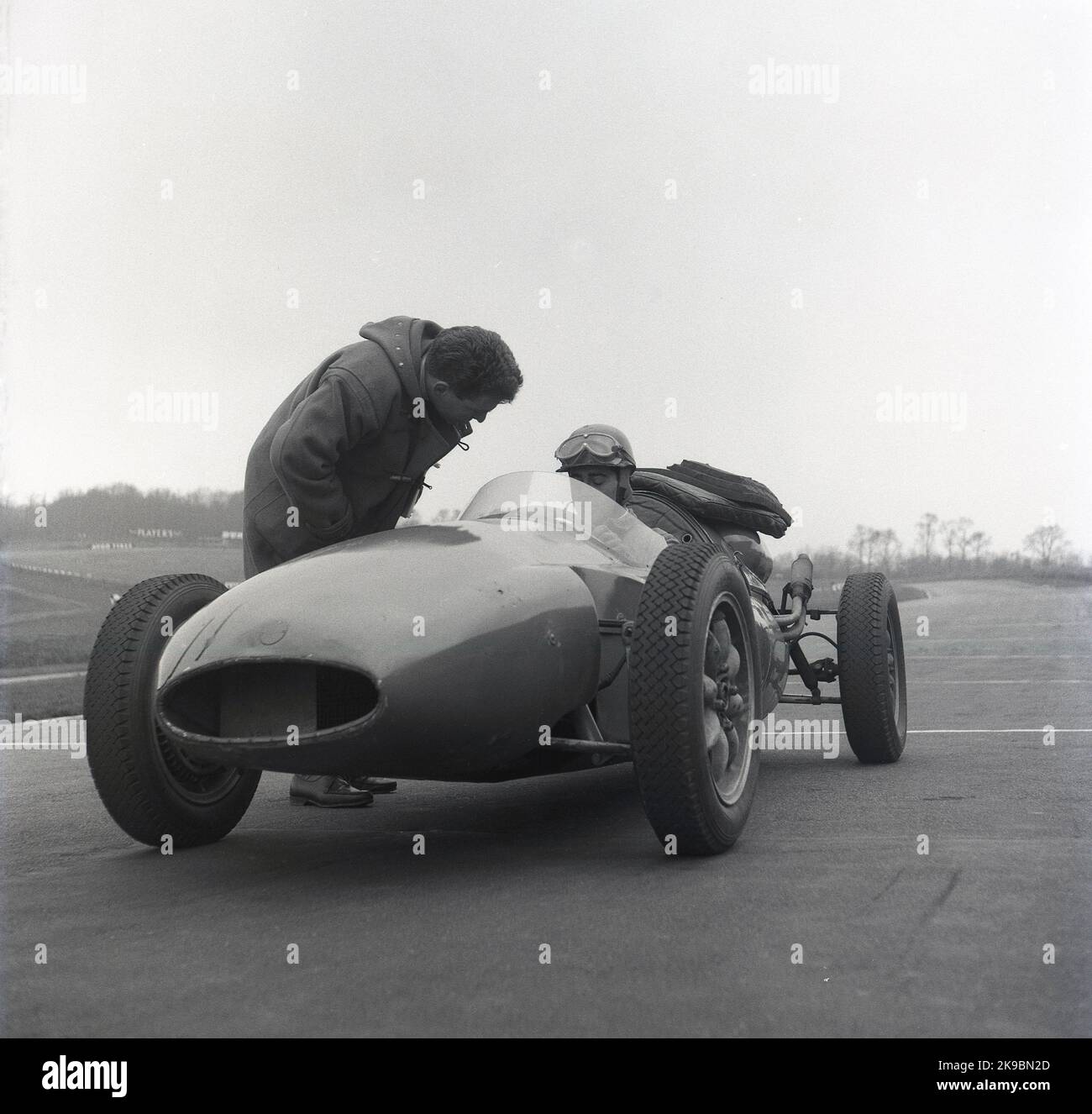 1959, historical, an instructor in a duffel coat talking to a driver ...