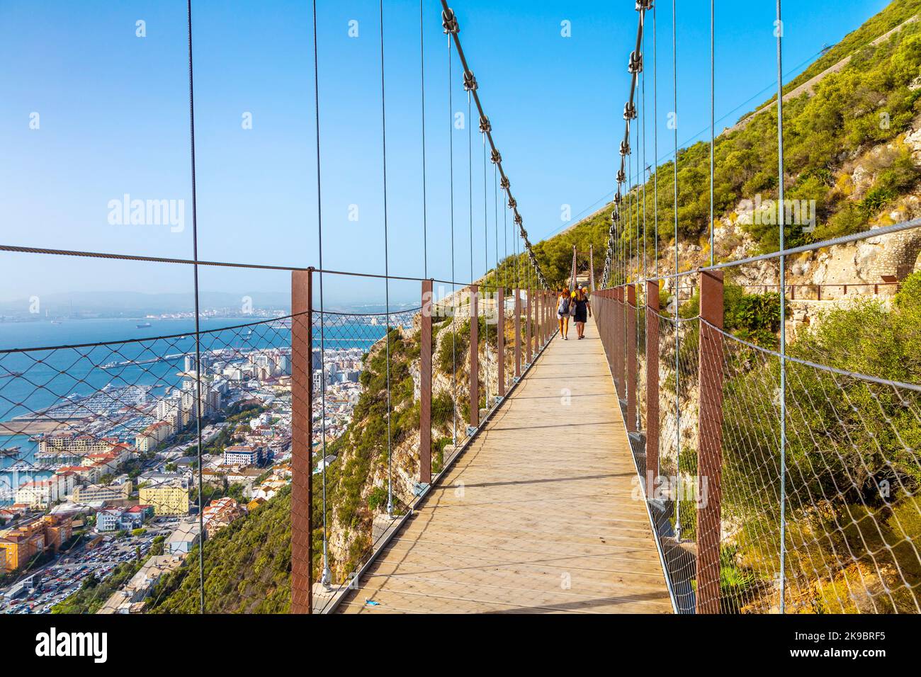 People walking across the Windsor Suspension Bridge at Gibraltar Rock and the Upper Rock Nature Reserve, Gibraltar Stock Photo