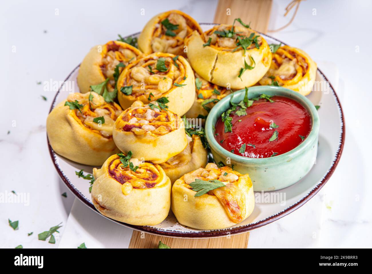 Homemade twisted Pizza rolls with tomato sauce, tomato, and cheese