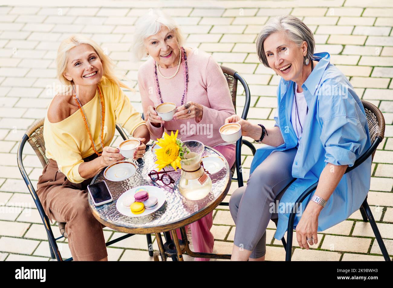 Old women gossip sitting hi-res stock photography and images - Alamy