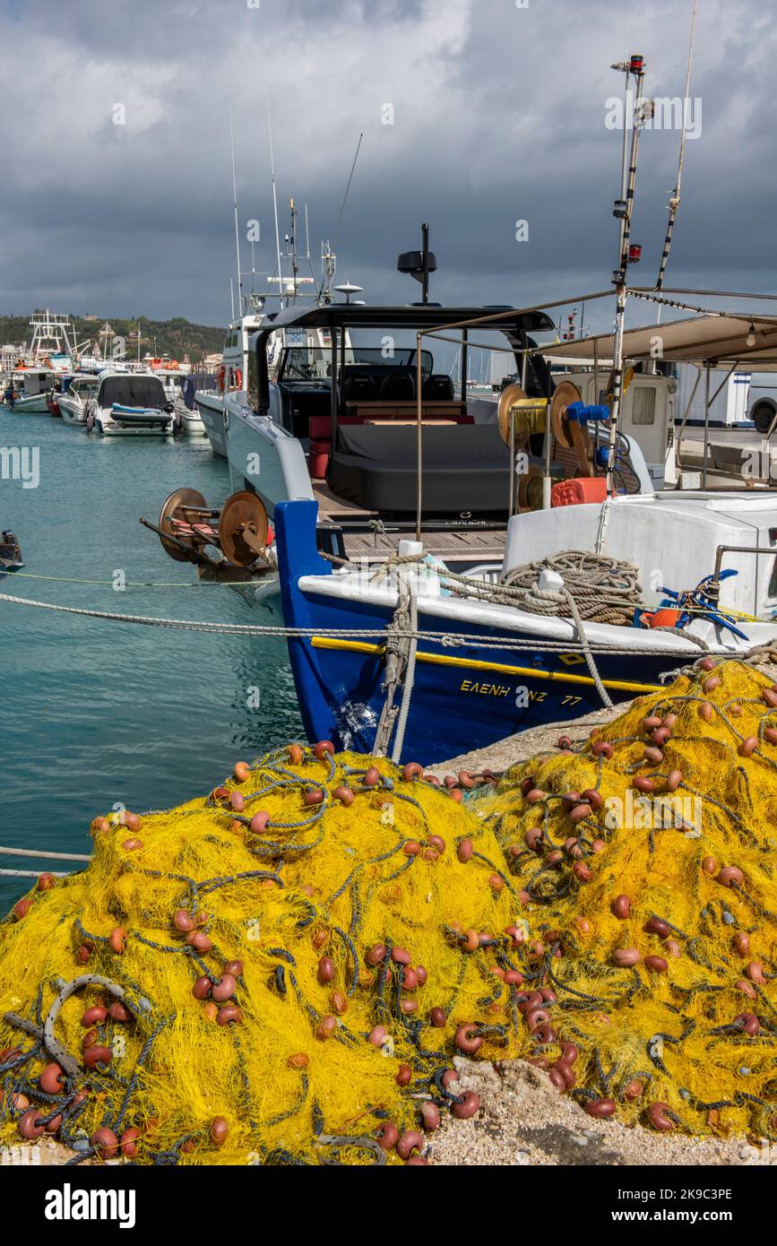 greek fishermen, greek trawlers, fishing nets and boats, colourful fishing equipment, netting, fishing gear, drying nets in greece, trawling nets. Stock Photo