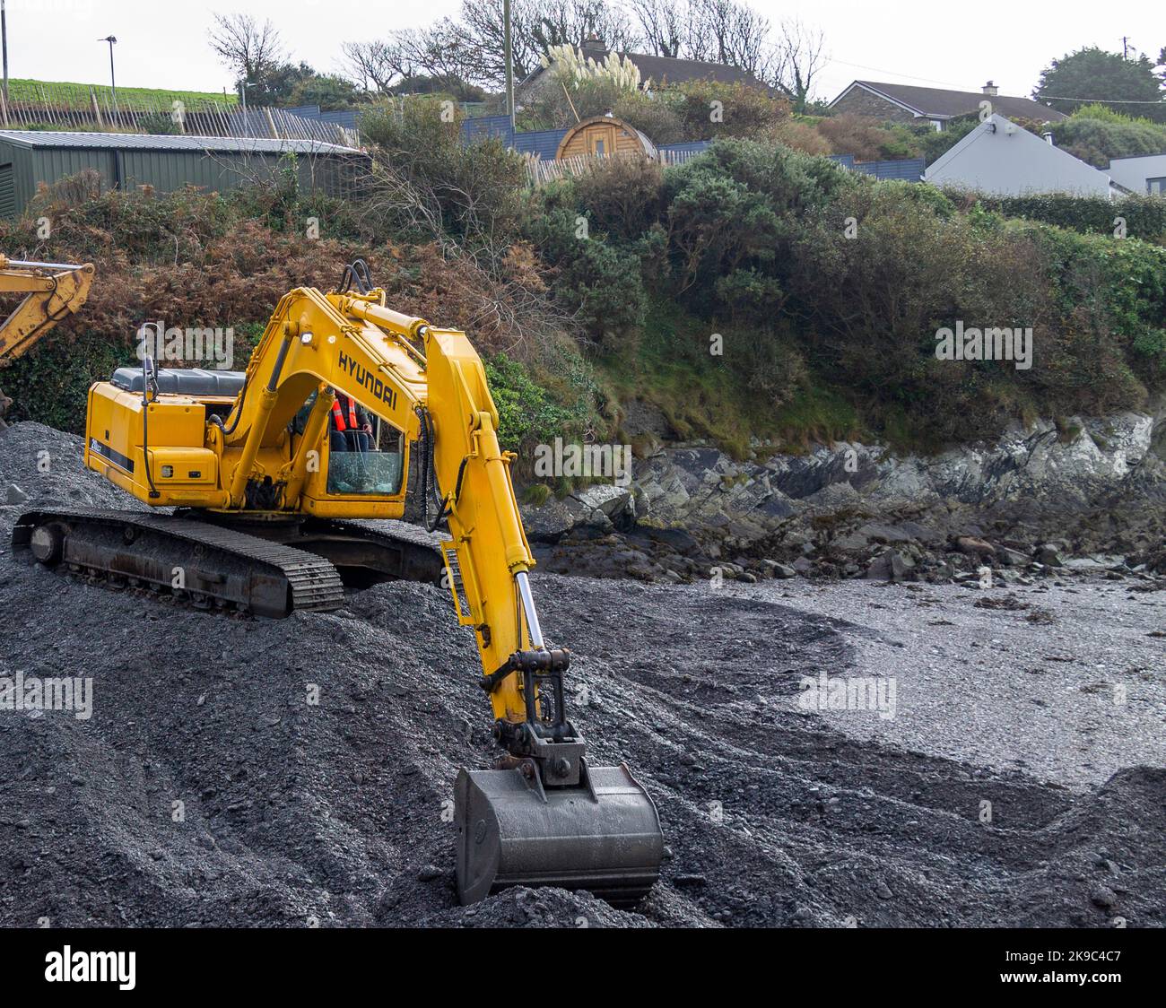 Hyundai 210LC-7 Excavator digging out a channel on the foreshore. Stock Photo