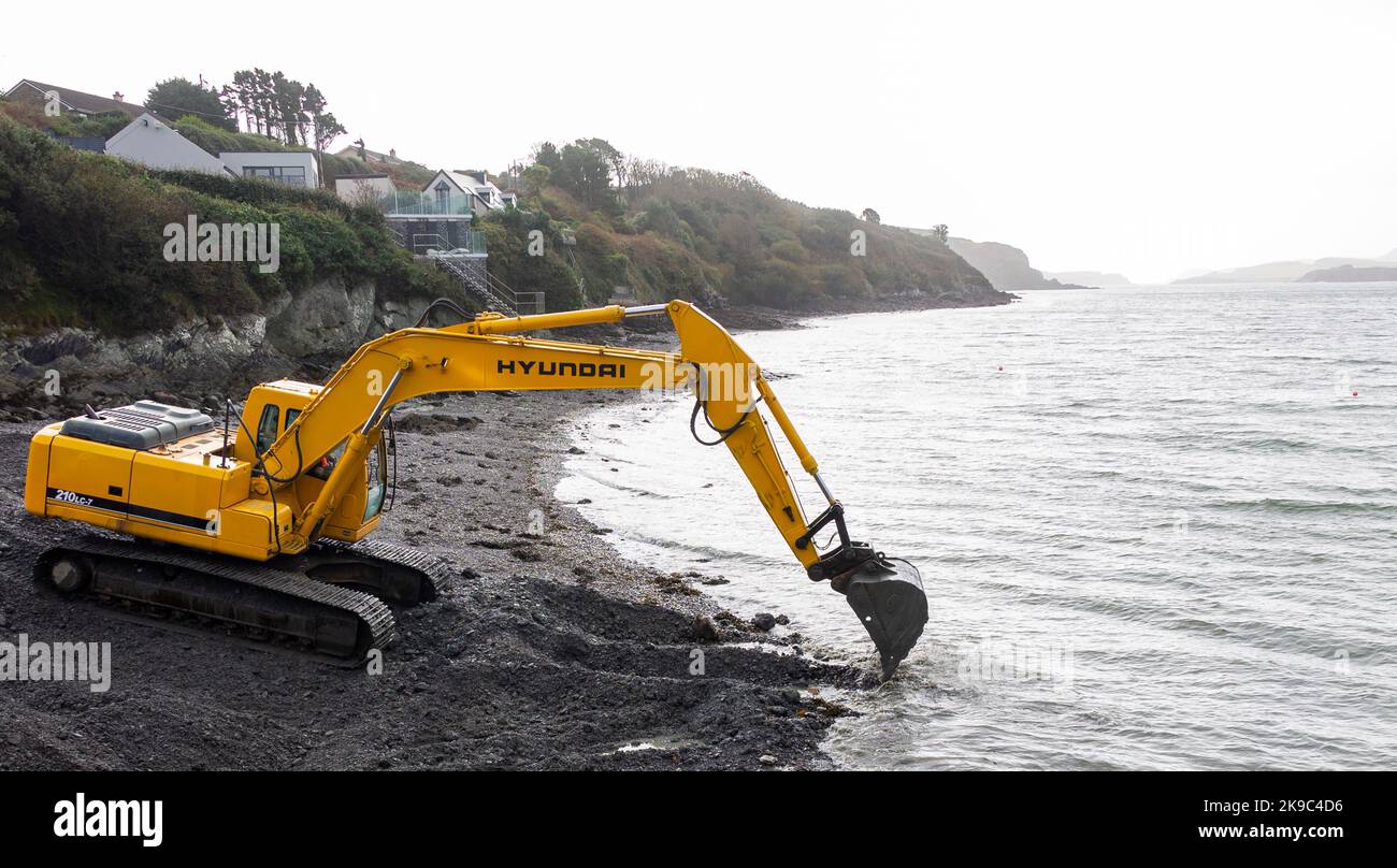 Hyundai 210LC-7 Excavator digging out a channel on the foreshore. Stock Photo