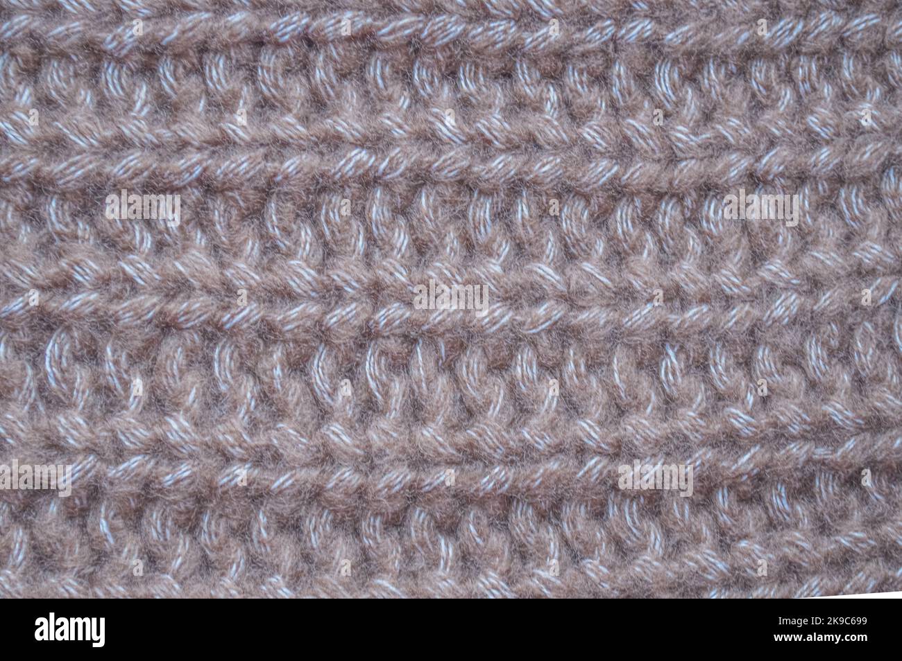 Handmade knit material with detail woven threads. Stock Photo