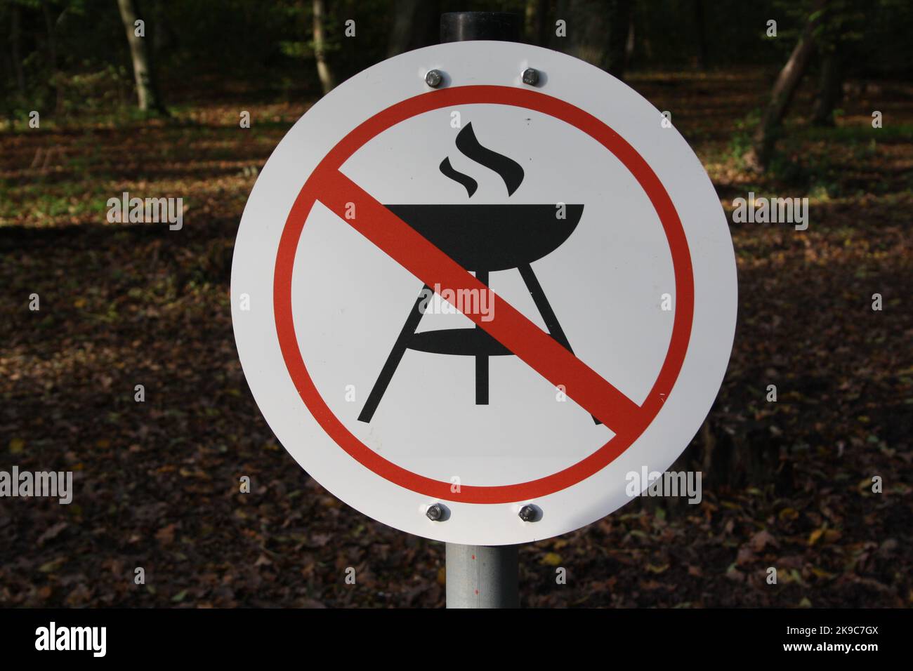 Sign 'Barbecue prohibited' on a barbecue area in the forest Stock Photo