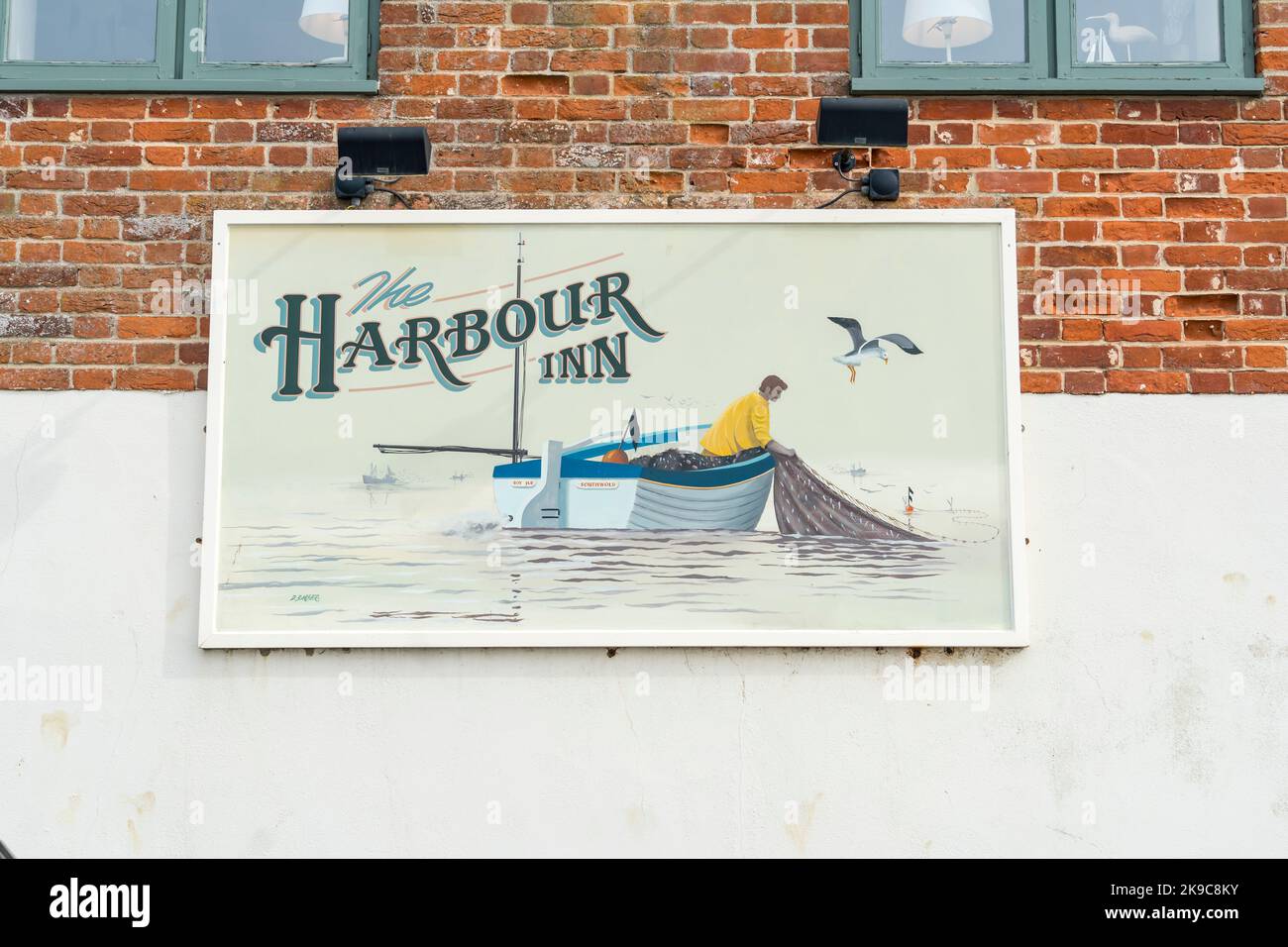 The Harbour Inn sign showing fisherman at sea in boat hauling net, Southwold harbour suffolk 2022 Stock Photo