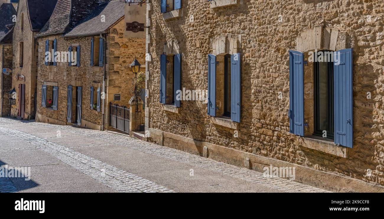 an old stone built house with blue painted wooden window shutters Stock ...