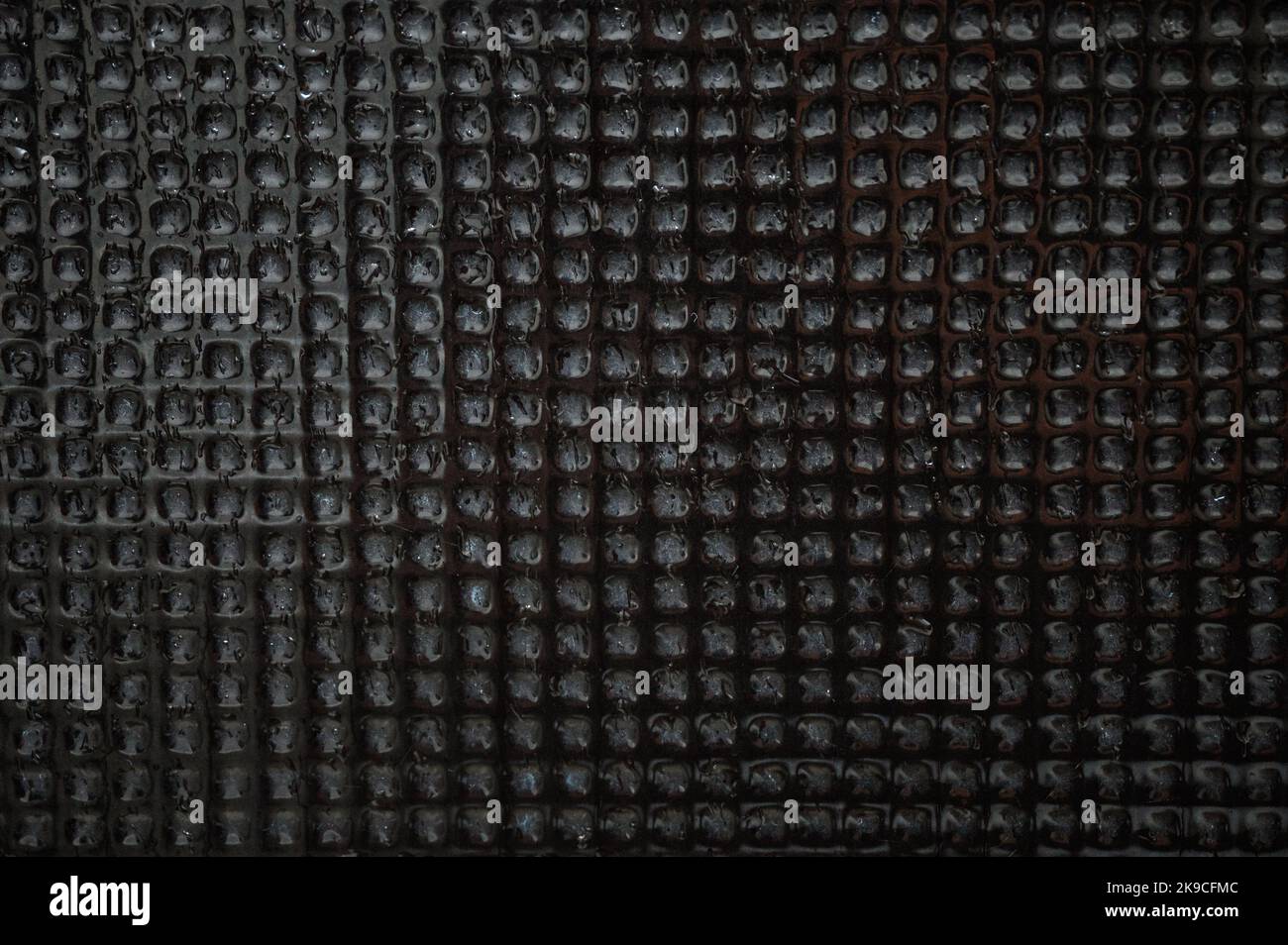 Surface mosaic black stone tiles wet background Stock Photo