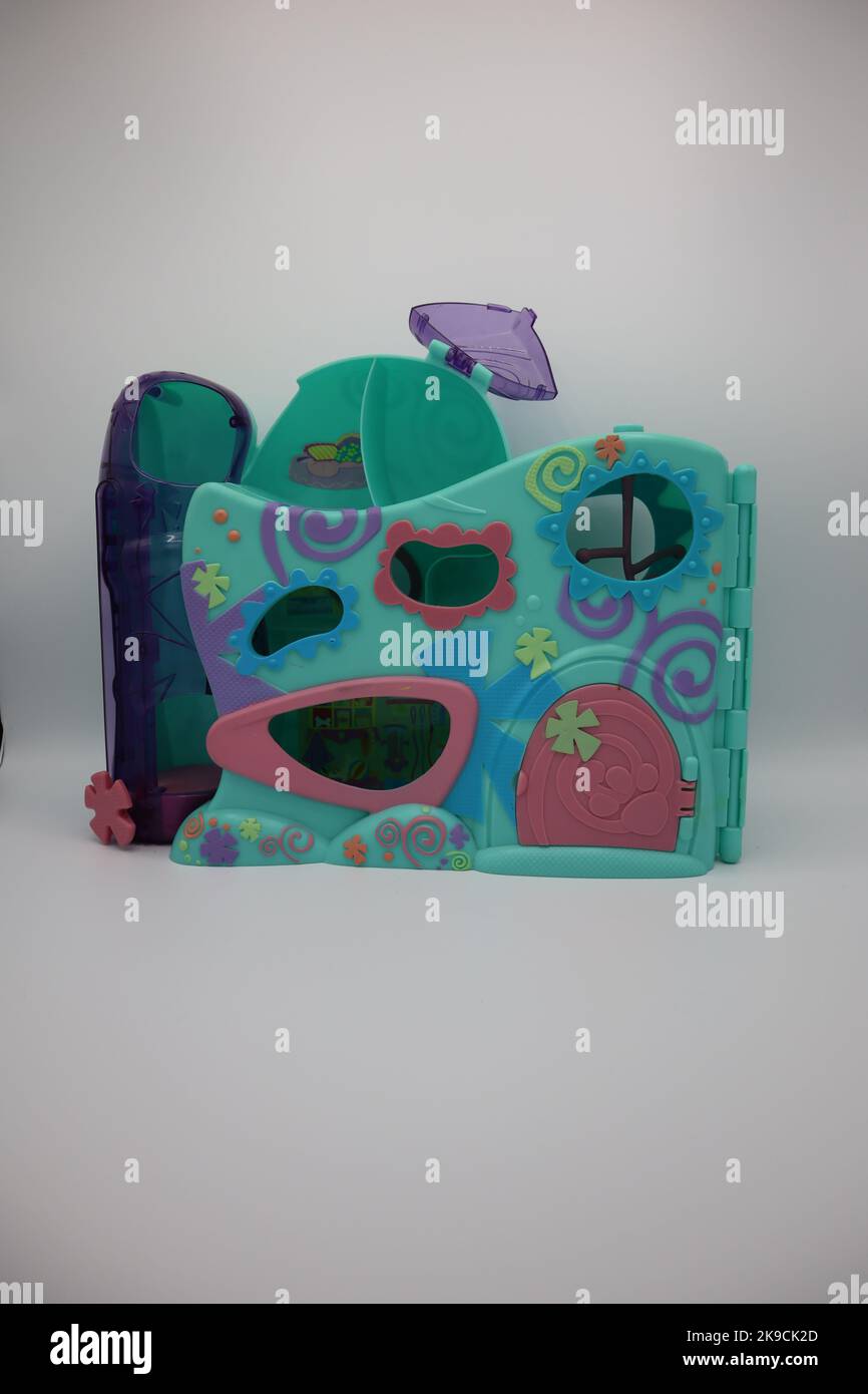 Plastic toy house with colorful walls on a white background