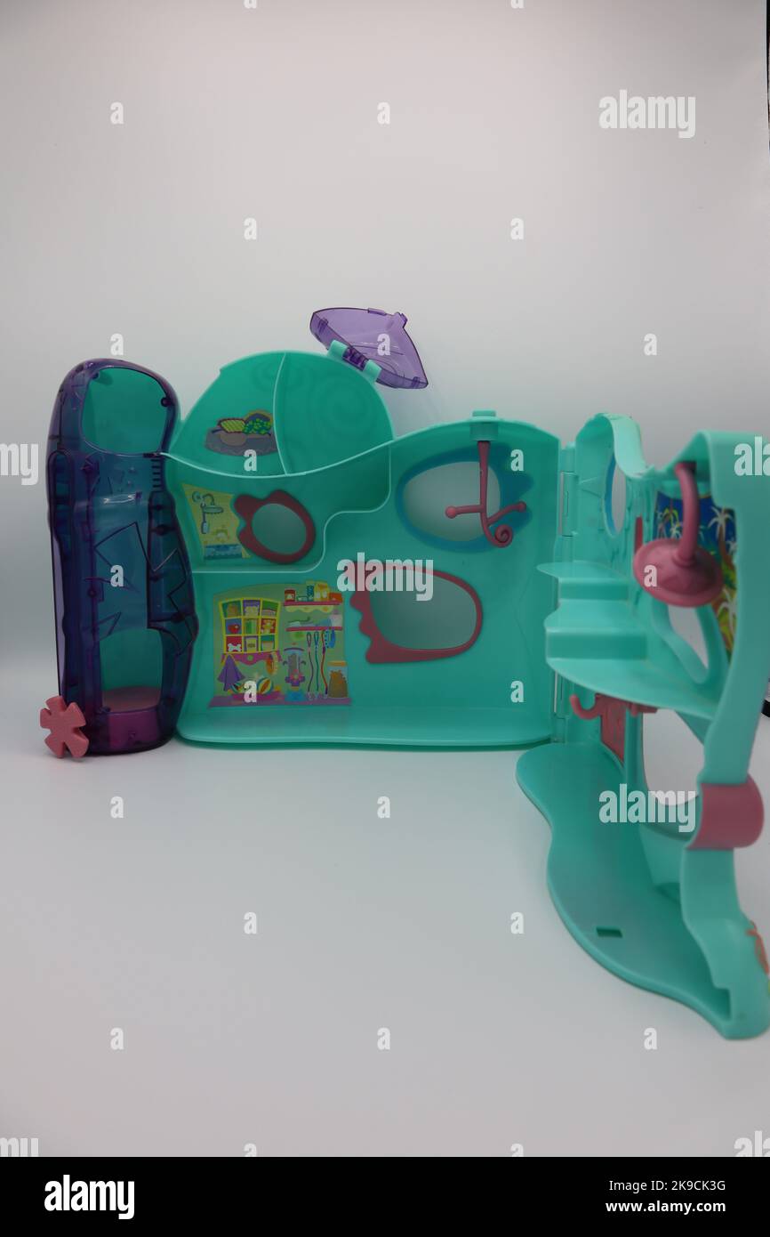 Plastic toy house with colorful walls on a white background